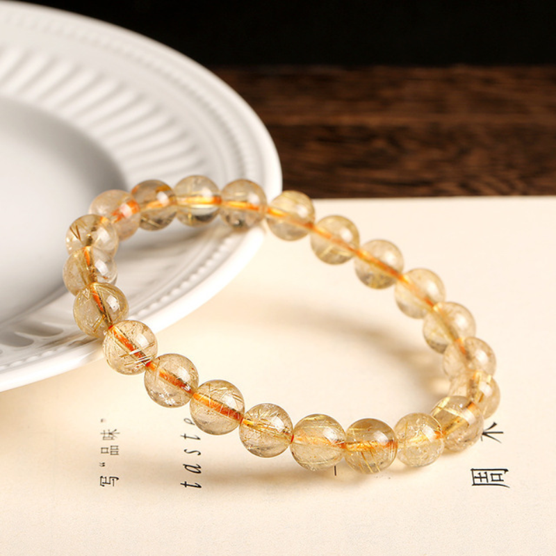 La pulsera de cristal de titanio "Purificación dorada"
